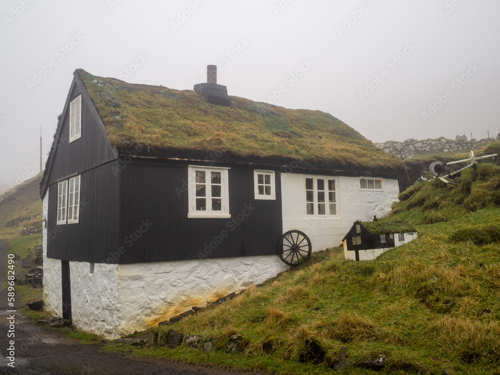 Mykines turf roofed house with smaller model on the side Mykines turf roofed house with smaller model on the side