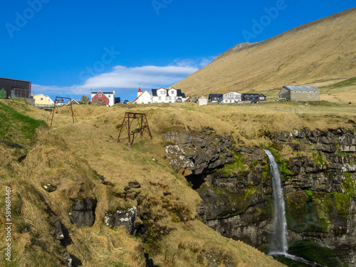 Mikladalur over the cliff and the waterfall photo