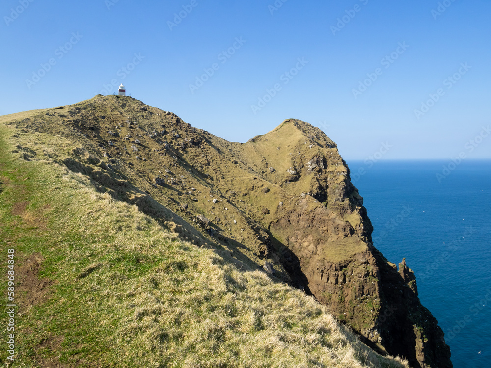 Kallur lighthouse at the end of the hiking path, by the cliffs edge of north Kalsoy Kallur lighthouse at the end of the hiking path, by the cliffs edge of north Kalsoy