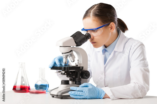 Young scientist looking through a microscope in the laboratory. photo