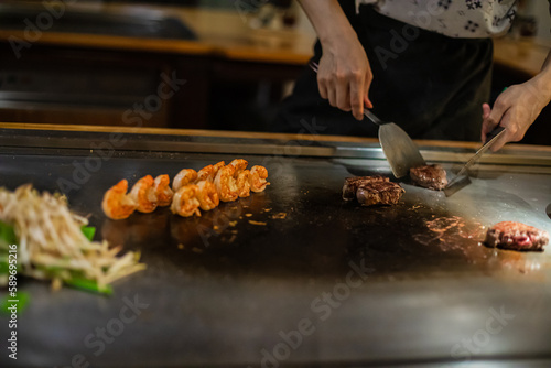 Tepanyaki - japanese grilled beef on pan. chef cooking at the hot table
