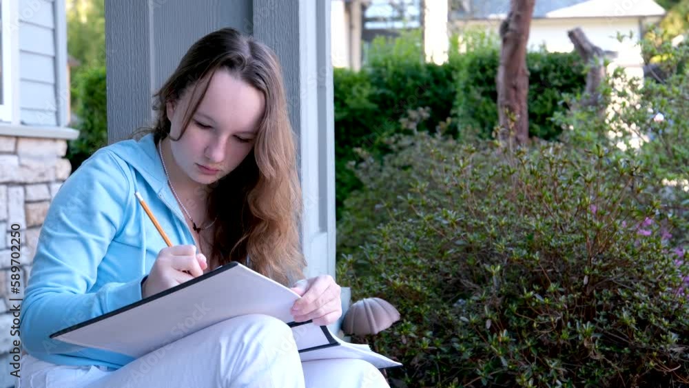 teenager girl sitting on porch of house in hands with pencil and white large sketchbook write solve problems online learning do homework sit in park study space for text ad beautiful real people teenager girl sitting on porch of house in hands with pencil and white large sketchbook write solve problems online learning do homework sit in park study space for text ad beautiful real people