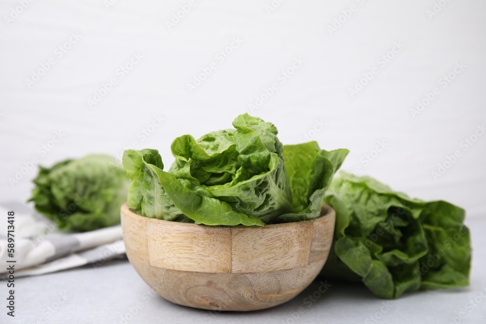 Fresh green romaine lettuces on grey table