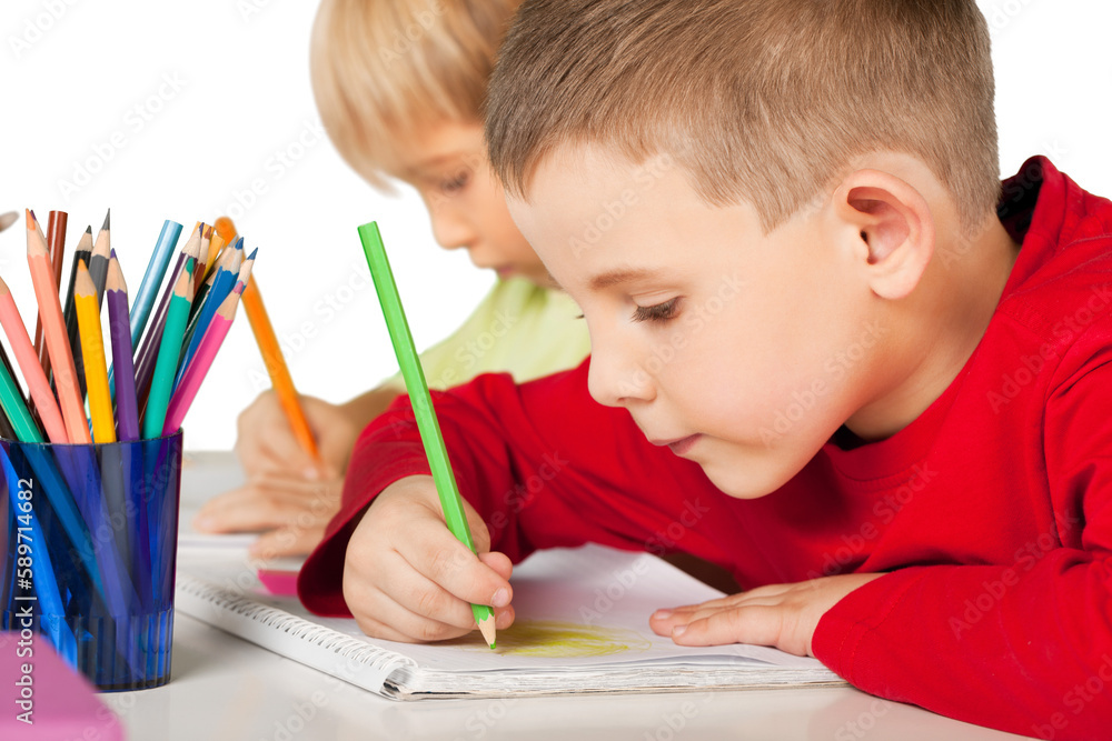 Boys drawing with pencils isolated on white Boys drawing with pencils isolated on white