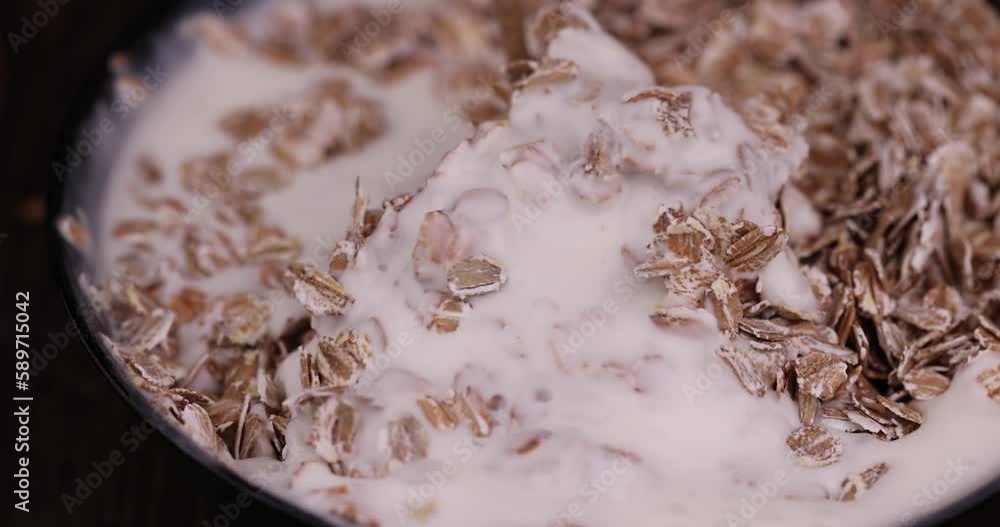 yogurt made from cow's milk with the addition of a large amount of oat flakes, a quick breakfast of oat flakes and dairy products yogurt made from cow's milk with the addition of a large amount of oat flakes, a quick breakfast of oat flakes and dairy products