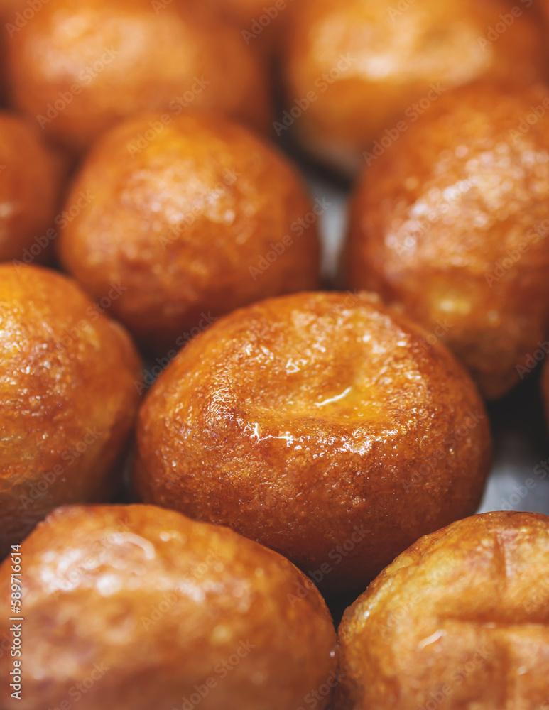Close-up view of Loukoumades dessert, greek donuts with honey and walnut, traditional greek lokma sweets and delights served in bakery cafe in Athens, Attica, Greece Close-up view of Loukoumades dessert, greek donuts with honey and walnut, traditional greek lokma sweets and delights served in bakery cafe in Athens, Attica, Greece