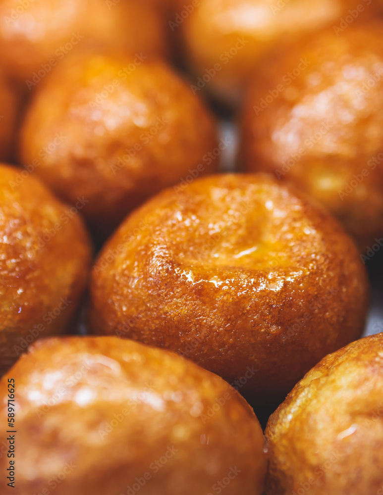 Close-up view of Loukoumades dessert, greek donuts with honey and walnut, traditional greek lokma sweets and delights served in bakery cafe in Athens, Attica, Greece