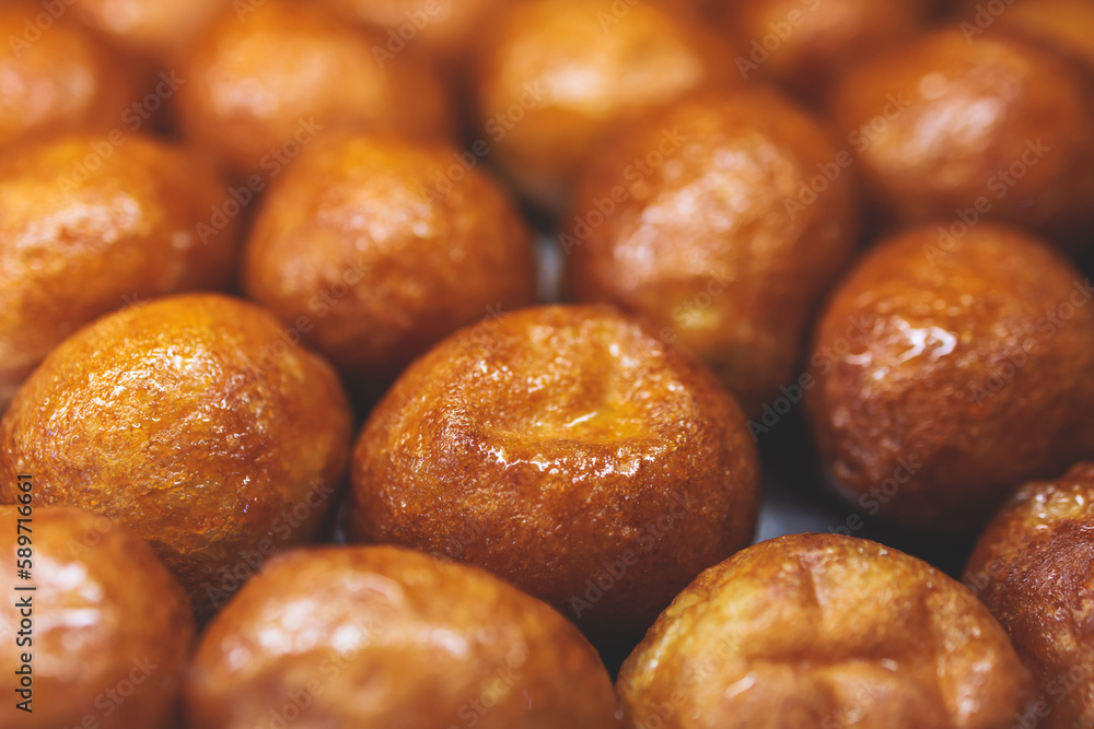 Close-up view of Loukoumades dessert, greek donuts with honey and walnut, traditional greek lokma sweets and delights served in bakery cafe in Athens, Attica, Greece Close-up view of Loukoumades dessert, greek donuts with honey and walnut, traditional greek lokma sweets and delights served in bakery cafe in Athens, Attica, Greece