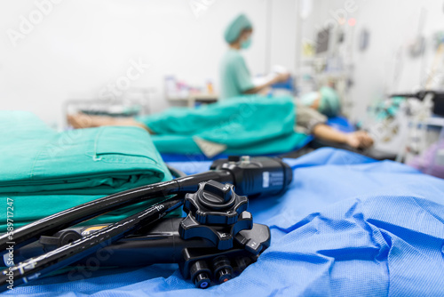 Medical colonoscopy or gastroscopy instrument on surgical table inside operating room in hospital.Endoscopic technology for cancer screening with blur background and space.Medical device for surgeon. photo