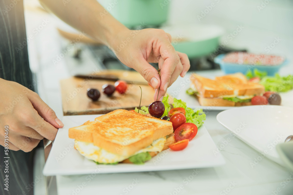 Woman cooking sandwich with salad in the rustic kitchen. Woman preparing tasty bruschettas in kitchen. Woman making tasty sandwich with salad on table. Woman cooking sandwich with salad in the rustic kitchen. Woman preparing tasty bruschettas in kitchen. Woman making tasty sandwich with salad on table.
