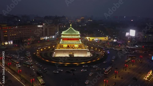 Xi'an city night street scene: Traffic circle around bright Bell Tower photo