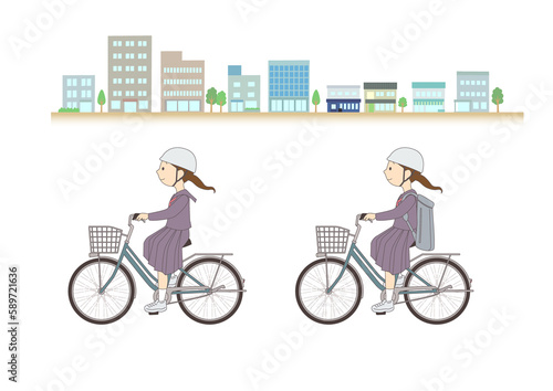街並みを背に自転車に乗る女子学生