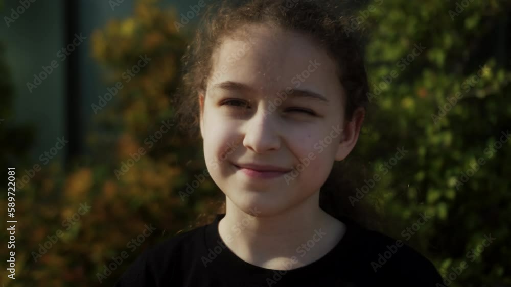 Portrait happy child in park. Beautiful face. Happy Child in rays of the sun. Little girl face in park close-up portrait. Dream funny girl.Happy face of child in rays of sun.Child smiles at camera. 4K Portrait happy child in park. Beautiful face. Happy Child in rays of the sun. Little girl face in park close-up portrait. Dream funny girl.Happy face of child in rays of sun.Child smiles at camera. 4K