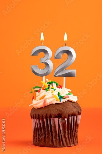 Candle number 32 - Cake birthday in orange background