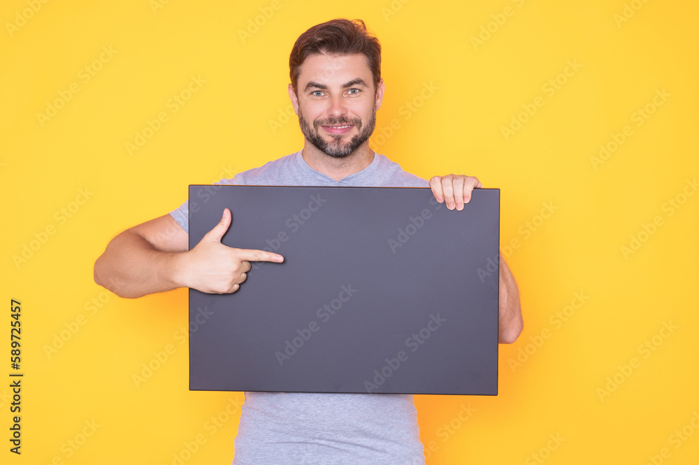 Man in studio showing promo blank board pointing finger on sign board. Blank signboard with copyspace. Advertisement concept. Ad board with copy space, blank mockup. Blank signboard, placard. Man in studio showing promo blank board pointing finger on sign board. Blank signboard with copyspace. Advertisement concept. Ad board with copy space, blank mockup. Blank signboard, placard.