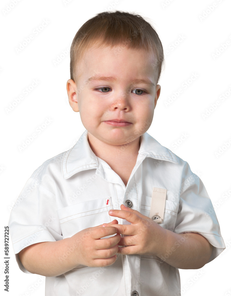 Young boy playing with his finger and looking sad