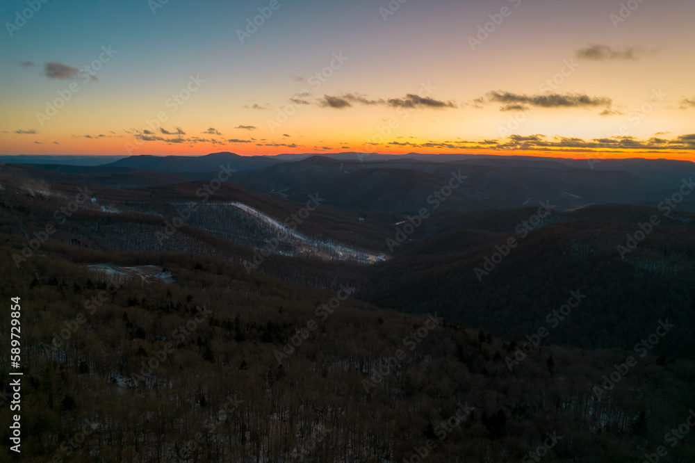 Aerial Drone View of West Virginia Snowshoe Mountain at Sunset with Some Snow