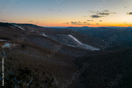 Aerial Drone View of West Virginia Snowshoe Mountain at Sunset with Some Snow