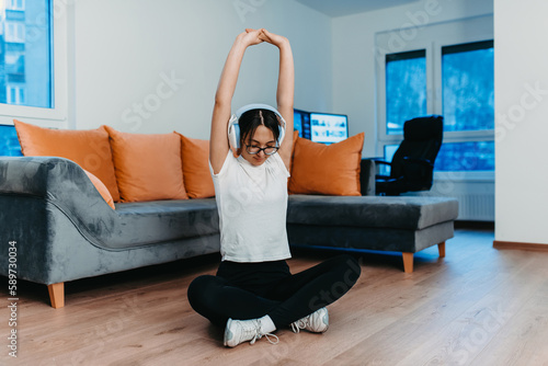 A woman stretching in her apartment during early morning after training , reflecting her dedication to a healthy lifestyle. This moment highlights the importance of regular exercise and self-care