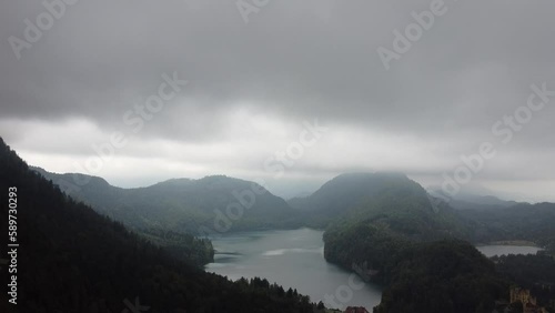 Aerial reveal view of Lake Lucerne Neuschwanstein Castle and the Swiss Alps