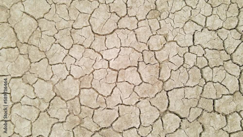 Top down aerial drone shot of desertic dry cracked mud ground soil farmland Top down aerial drone shot of desertic dry cracked mud ground soil farmland