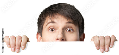 Young man peering over a blank sign photo