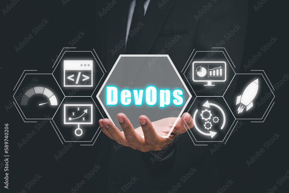 DevOps concept, Person hand holding DevOps icon on VR screen, Methodology development operations agil programming technology.concept. DevOps concept, Person hand holding DevOps icon on VR screen, Methodology development operations agil programming technology.concept.