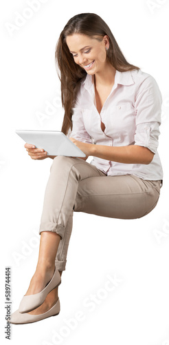 Fotografie Portrait of a young  pretty woman sitting with tablet pc isolated on background