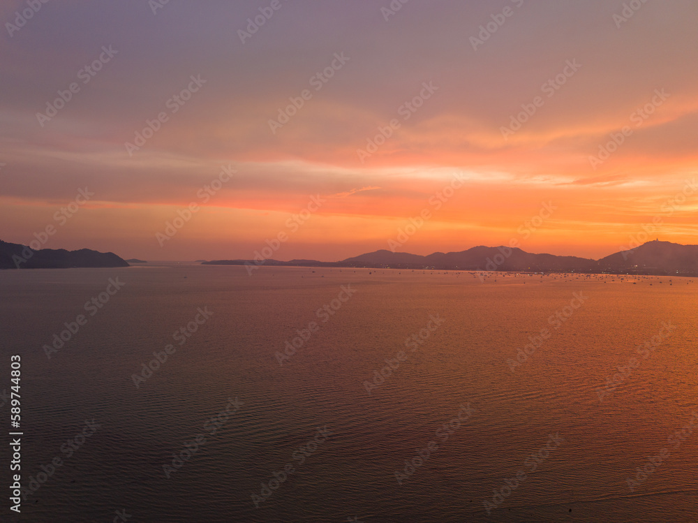 .aerial view stunning sky in sunset above the sea..colorful cloud in bright sky of sunset above the ocean at Khao Khad Phuket. .Majestic sunset or sunrise landscape Amazing light of nature 