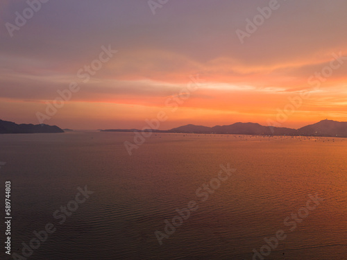 .aerial view stunning sky in sunset above the sea..colorful cloud in bright sky of sunset above the ocean at Khao Khad Phuket. .Majestic sunset or sunrise landscape Amazing light of nature  © Narong Niemhom
