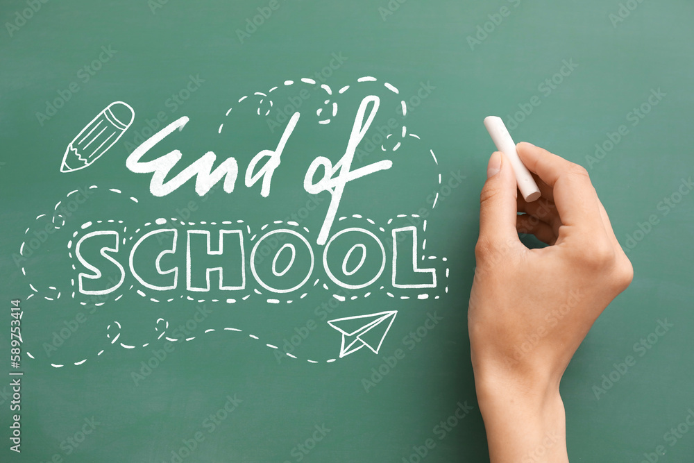 Hand writing text END OF SCHOOL on blackboard Hand writing text END OF SCHOOL on blackboard