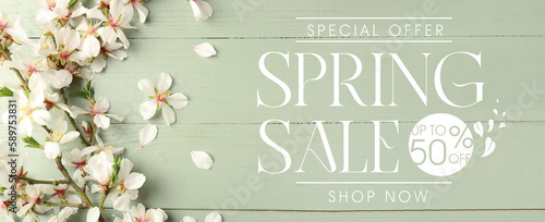 Beautiful blossoming tree branches on green wooden background. Spring sale photo