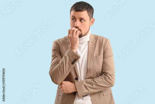 Handsome businessman biting...