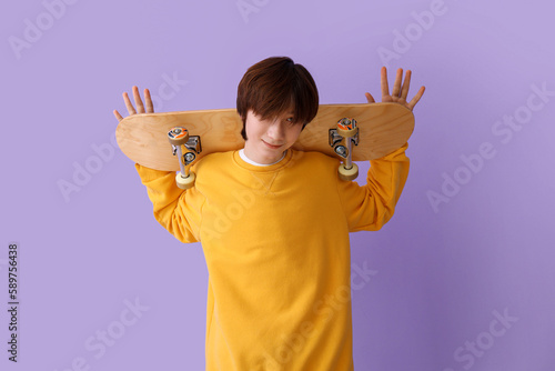 Teenage boy with skateboard...