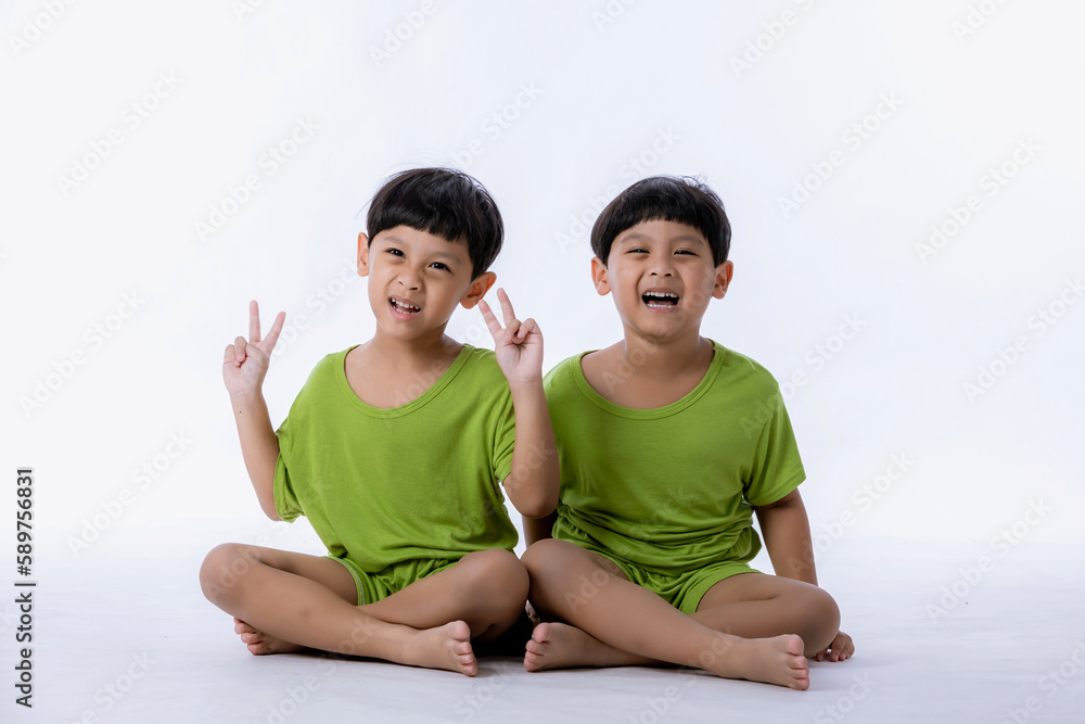 Portrait of cute Asian twins boys. two little boys twins isolated on white background. twins boys fun together on white background Portrait of cute Asian twins boys. two little boys twins isolated on white background. twins boys fun together on white background