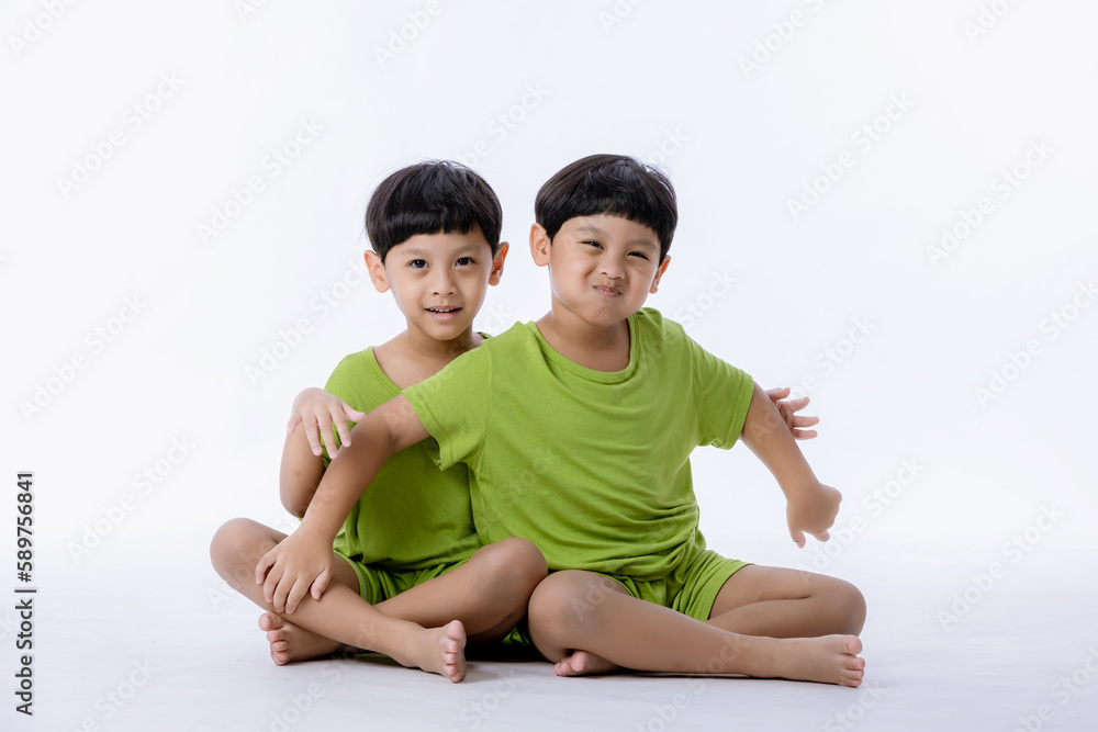 Portrait of cute Asian twins boys. two little boys twins isolated on white background. twins boys fun together on white background