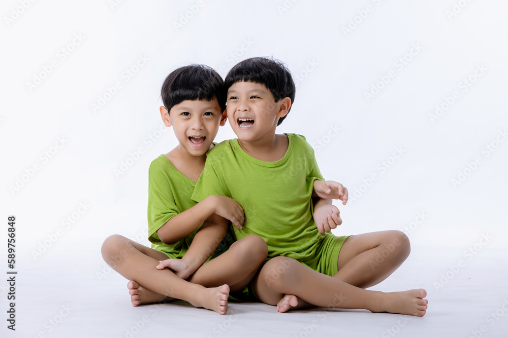 Portrait of cute Asian twins boys. two little boys twins isolated on white background. twins boys fun together on white background Portrait of cute Asian twins boys. two little boys twins isolated on white background. twins boys fun together on white background