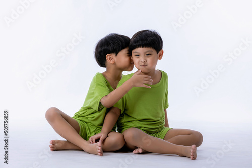 Portrait of cute Asian twins boys. two little boys twins isolated on white background. twins boys fun together on white background