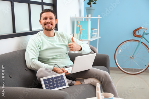 Handsome man with laptop ch...