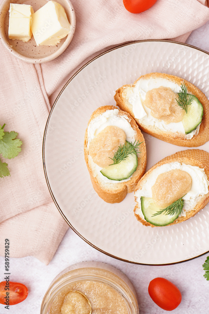 Delicious canapes with caviar of capelin on grey background