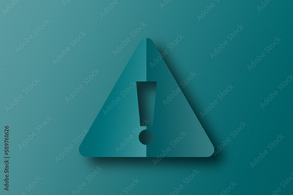 Cut green paper into exclamation mark shapes. warning sign set on green paper background Cut green paper into exclamation mark shapes. warning sign set on green paper background