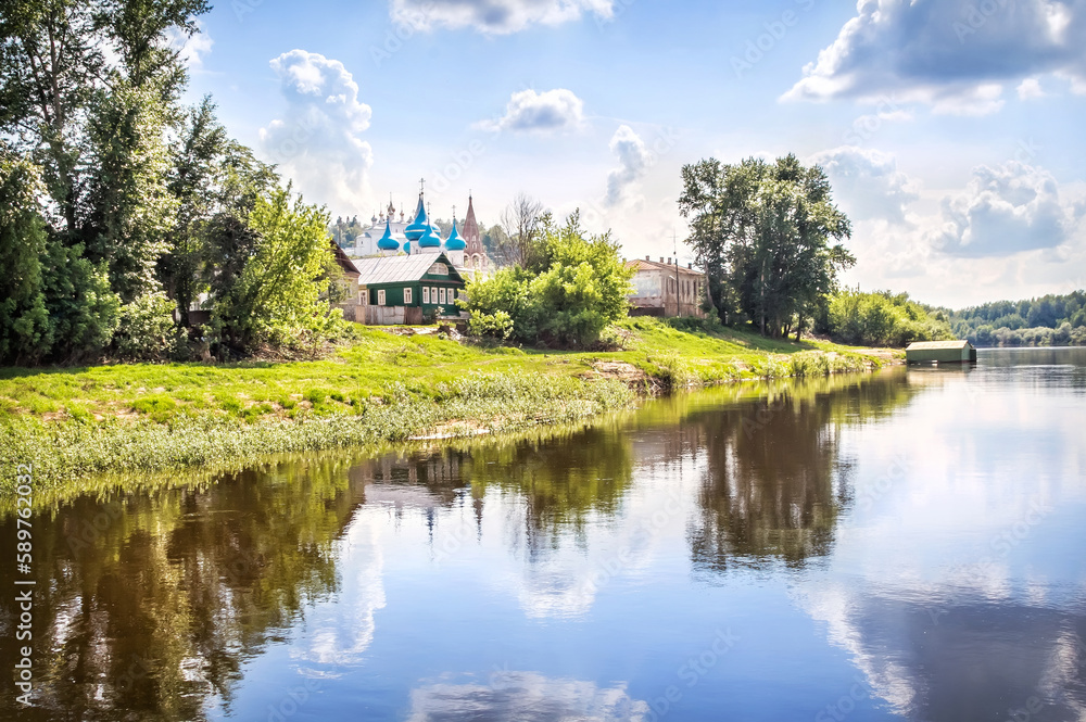 Cathedral of the Annunciation with blue domes and houses with reflection in the Klyazma river, Gorokhovets Cathedral of the Annunciation with blue domes and houses with reflection in the Klyazma river, Gorokhovets