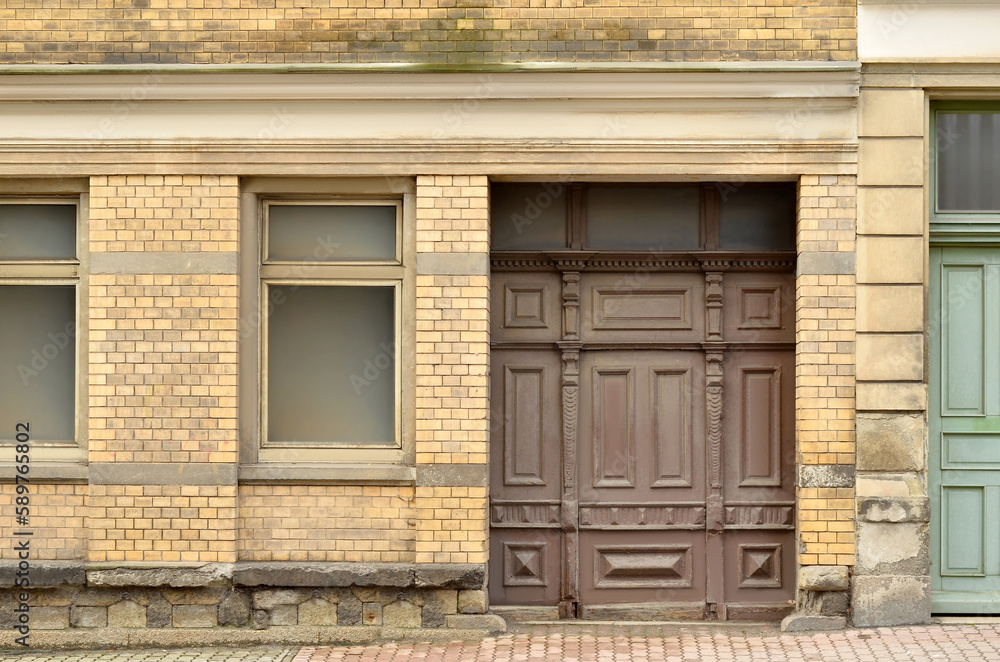 View of brick building with wooden door and windows View of brick building with wooden door and windows