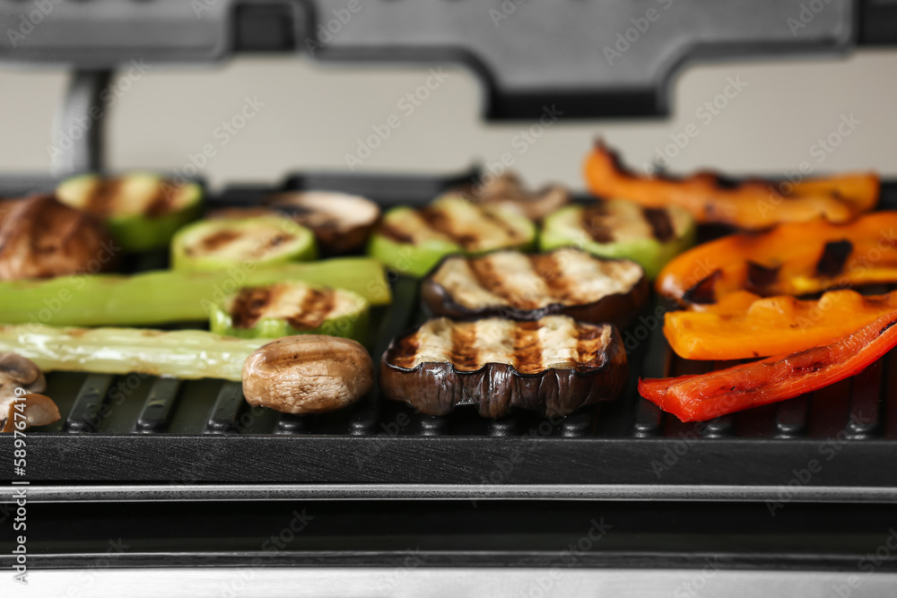Tasty vegetables on modern electric grill, closeup Tasty vegetables on modern electric grill, closeup