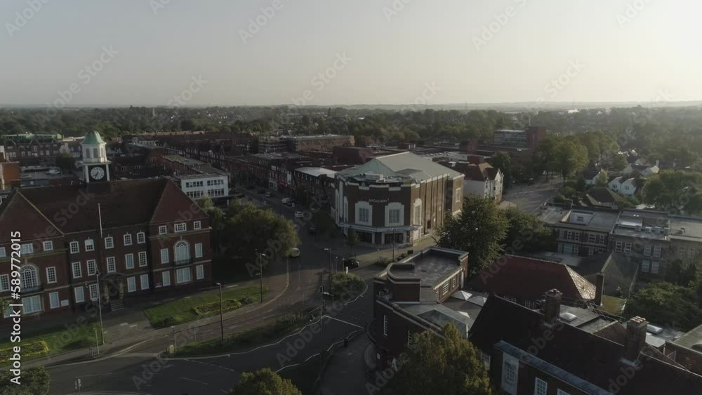Slow climb with drone of an arthouse cinema surrounded by 19th century buildings and traffic in a town centre early morning in Letchworth Garden City Slow climb with drone of an arthouse cinema surrounded by 19th century buildings and traffic in a town centre early morning in Letchworth Garden City