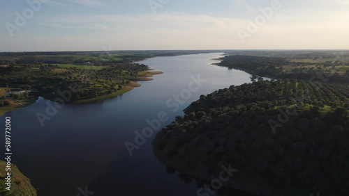  Landscape of the Guadiana River flowing through a lush forest near Beja in Portugal photo