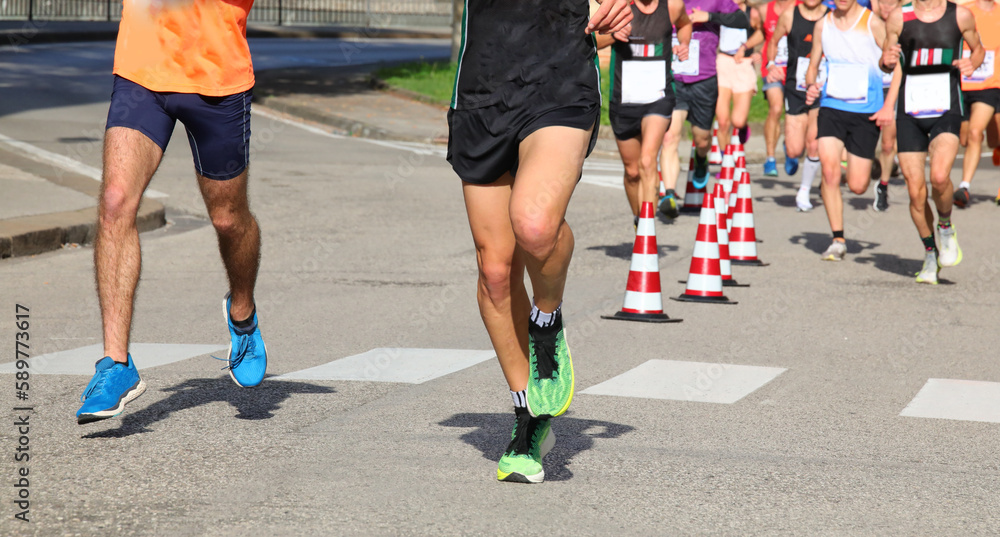 runners during the marathon on the city streets run in sneakers runners during the marathon on the city streets run in sneakers