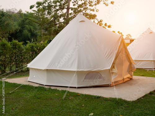 Camping picnic tent campground in outdoor hiking forest. Camper while campsite in nature background at summer trip camp. Adventure Travel Vacation concept © Thawatchai Images