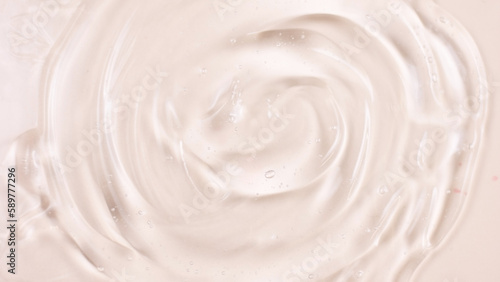 Cosmetic product texture, moisturizing lotion isolated on pink background, squeezed out and smeared portion of skincare cream product testing