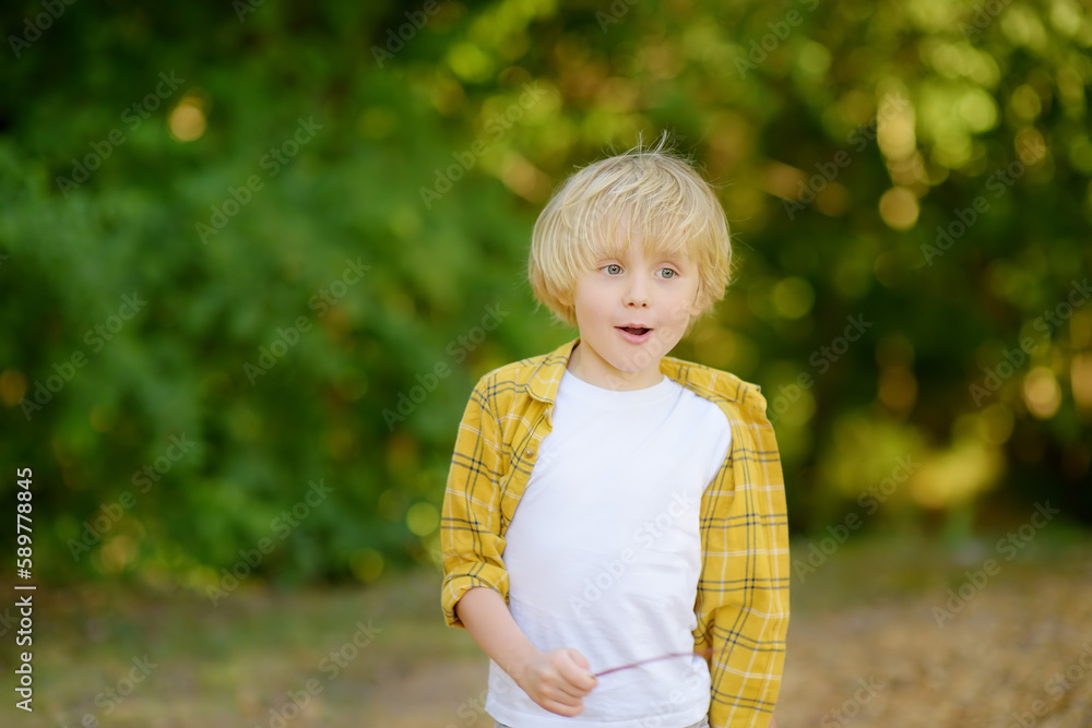Portrait of cheerful smiling preschooler child during summer holidays on sunny day. Concept of freedom, happy childhood and limitless possibilities. Portrait of cheerful smiling preschooler child during summer holidays on sunny day. Concept of freedom, happy childhood and limitless possibilities.